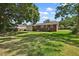 Large, grassy backyard with mature trees providing ample shade and privacy at 5321 Trudy St, North Charleston, SC 29418