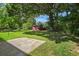 Picturesque backyard featuring a storage shed, mature trees and patio space at 5321 Trudy St, North Charleston, SC 29418