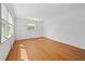 Bright, empty bedroom featuring hardwood floors, white walls, and natural light from a large window at 5321 Trudy St, North Charleston, SC 29418