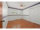 This bedroom has wood floors, Braves-themed wallpaper, a ceiling fan and a double-door closet at 5321 Trudy St, North Charleston, SC 29418