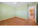 A bedroom with green walls, wood floors and a view to another room through the doorway at 5321 Trudy St, North Charleston, SC 29418