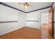 This bedroom features wood floors, Braves-themed wallpaper, a ceiling fan, and a double-door closet at 5321 Trudy St, North Charleston, SC 29418