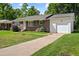 Charming single-story brick home with shutters, well-kept lawn, and attached single-car garage at 5321 Trudy St, North Charleston, SC 29418