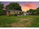 Charming home with lush front lawn, landscaping, mature shade trees, and driveway at 5321 Trudy St, North Charleston, SC 29418