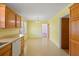 The eat-in kitchen features bright yellow walls, oak cabinets and a dishwasher at 5321 Trudy St, North Charleston, SC 29418