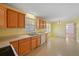 The eat-in kitchen features bright yellow walls, oak cabinets and a double-bowl sink at 5321 Trudy St, North Charleston, SC 29418
