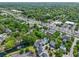 Aerial view of townhomes near lush greenery and a busy road with a wide variety of commercial establishments at 539 Cooper Village Ln, Mount Pleasant, SC 29464