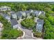 Scenic aerial view of gray and white townhomes in a neighborhood with tree-lined streets and cul-de-sac at 539 Cooper Village Ln, Mount Pleasant, SC 29464