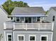A lovely outdoor deck with white railings and partial awning, perfect for enjoying the outdoor scenery at 539 Cooper Village Ln, Mount Pleasant, SC 29464