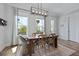 Charming dining room features hardwood table with six chairs, and a stylish chandelier with outdoor view at 539 Cooper Village Ln, Mount Pleasant, SC 29464