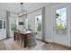 Bright dining room includes a wooden table with six chairs, a decorative rug and plenty of natural light at 539 Cooper Village Ln, Mount Pleasant, SC 29464