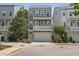 Exterior view of a three-story townhome with well-kept landscaping, a garage, and multiple balconies at 539 Cooper Village Ln, Mount Pleasant, SC 29464