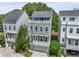 A three-story townhome featuring a top deck, lower level balconies, a garage, and neutral exterior paint at 539 Cooper Village Ln, Mount Pleasant, SC 29464