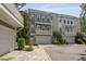 Exterior of a three-story townhome with a garage, balconies, and well-maintained landscaping at 539 Cooper Village Ln, Mount Pleasant, SC 29464