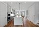 Well-lit kitchen featuring an island with seating, hardwood floors, and stainless steel appliances at 539 Cooper Village Ln, Mount Pleasant, SC 29464