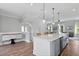 Open concept kitchen featuring an island with sink, hardwood floors, and stainless steel dishwasher at 539 Cooper Village Ln, Mount Pleasant, SC 29464