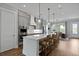 Gourmet kitchen featuring custom cabinetry, stainless steel appliances, and a large island with seating at 539 Cooper Village Ln, Mount Pleasant, SC 29464