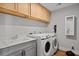 Bright laundry room with sink, lots of storage, and modern washer and dryer at 539 Cooper Village Ln, Mount Pleasant, SC 29464