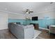 Inviting living room with a comfy sectional couch, TV, and stylish wainscoting at 539 Cooper Village Ln, Mount Pleasant, SC 29464