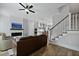 Bright, open-concept living space with a modern fireplace, sleek TV, and comfortable leather sofa at 539 Cooper Village Ln, Mount Pleasant, SC 29464