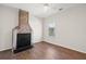 Bedroom featuring hardwood floors and a historic brick fireplace at 55 Maple St, Charleston, SC 29403