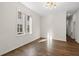 Bright room featuring hardwood floors, a large window, modern light fixture and neutral walls at 55 Maple St, Charleston, SC 29403
