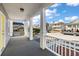 Inviting front porch with white columns and railings, offering a view of the neighborhood at 55 Maple St, Charleston, SC 29403