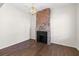 Bright room featuring hardwood floors, a brick fireplace, modern light fixture and neutral walls at 55 Maple St, Charleston, SC 29403