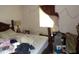 Bedroom with a bed, side table, lamp, and an abundance of personal items at 604 King St, Walterboro, SC 29488