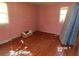 Unfurnished bedroom with hardwood floors and natural light from two windows at 604 King St, Walterboro, SC 29488
