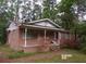 Charming brick home featuring a covered front porch, perfect for enjoying the outdoors at 604 King St, Walterboro, SC 29488