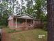 Charming brick home featuring a covered front porch, perfect for enjoying the outdoors at 604 King St, Walterboro, SC 29488