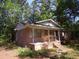 Charming brick home featuring a covered front porch, perfect for enjoying the outdoors at 604 King St, Walterboro, SC 29488