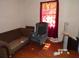 Living room featuring a sofa, armchair, window with curtains, and wood-style floors at 604 King St, Walterboro, SC 29488