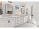 Bathroom featuring double sinks, marble floors, white cabinets, and modern lighting fixtures at 619 Trio Ln, Summerville, SC 29486