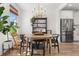 Bright dining room with a decorative china cabinet, round table, and modern lighting fixture at 619 Trio Ln, Summerville, SC 29486