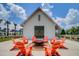 Communal fire pit with Adirondack chairs is perfect for gathering and enjoying outdoor evenings at 619 Trio Ln, Summerville, SC 29486