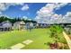Beautiful street view of homes overlooking a lush green lawn and play area, perfect for Gathering-friendly living at 619 Trio Ln, Summerville, SC 29486