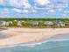 Scenic aerial view of beachfront homes next to sandy shores and a calm ocean at 67 Lost Village Trl # 4, Edisto Island, SC 29438