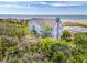 Scenic aerial view of the property backing to the beach, surrounded by lush trees and marshland at 67 Lost Village Trl # 4, Edisto Island, SC 29438