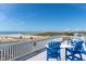 Relax on this scenic balcony with blue chairs and views of the water and beach at 67 Lost Village Trl # 4, Edisto Island, SC 29438