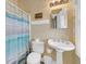 Cozy bathroom with pedestal sink and a shower featuring a striped curtain at 67 Lost Village Trl # 4, Edisto Island, SC 29438