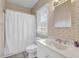 Classic bathroom with a white vanity, toilet, and shower with a neutral shower curtain at 67 Lost Village Trl # 4, Edisto Island, SC 29438