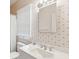 Well-lit bathroom featuring a decorative wallpaper, a window, and a single sink at 67 Lost Village Trl # 4, Edisto Island, SC 29438