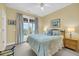 Bright bedroom featuring balcony access, wicker nightstands, and coastal decor at 67 Lost Village Trl # 4, Edisto Island, SC 29438
