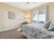Comfortable bedroom boasts a ceiling fan, accent chair, and balcony access at 67 Lost Village Trl # 4, Edisto Island, SC 29438