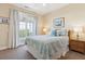 Comfortable bedroom featuring a double bed, outdoor access, and stylish decor at 67 Lost Village Trl # 4, Edisto Island, SC 29438