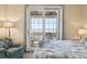 This bedroom features great views, a cozy chair, and access to a balcony at 67 Lost Village Trl # 4, Edisto Island, SC 29438