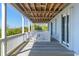 Expansive wooden deck with white railings and doors to the interior of the home at 67 Lost Village Trl # 4, Edisto Island, SC 29438