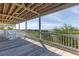 Spacious wooden deck featuring white railings and rocking chairs with gorgeous ocean views at 67 Lost Village Trl # 4, Edisto Island, SC 29438